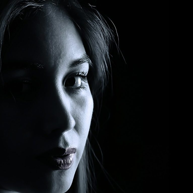 Shady Lady A profile of a woman with long hair, illuminated against a dark background.