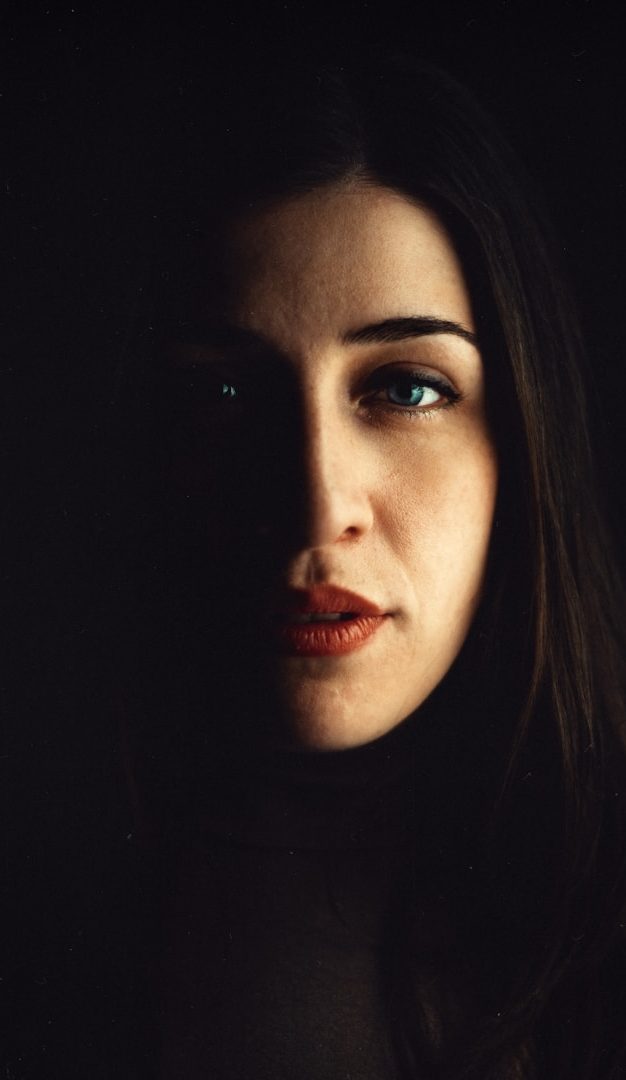 Shaded Lady A woman’s face partially illuminated, creating strong contrasts of light and shadow.